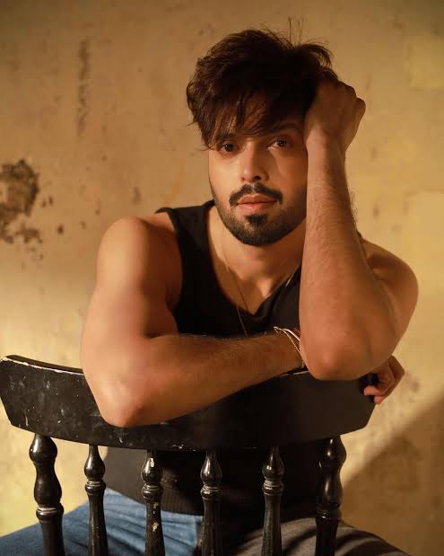 Fahad Mustafa posing in a stylish outfit during a glamorous photoshoot.