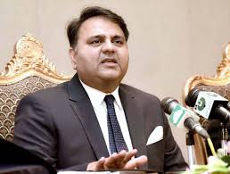 Fawad Chaudhry speaking at a press conference in formal attire