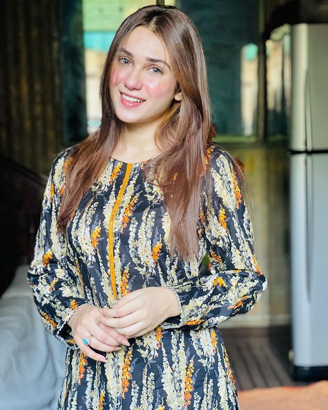 “Hina Tariq smiling at the camera”