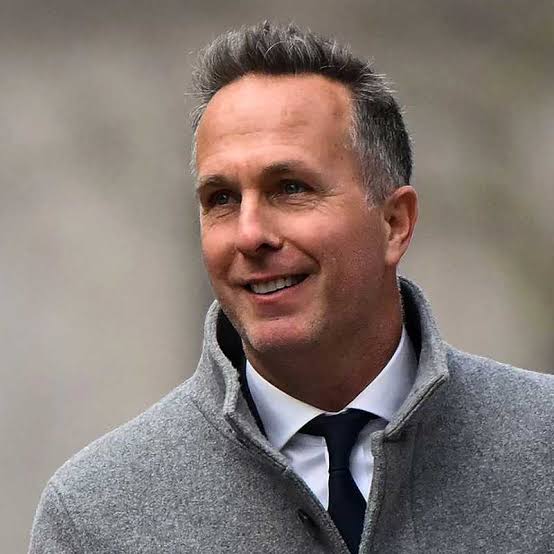 Michael Vaughan smiling while wearing a gray coat