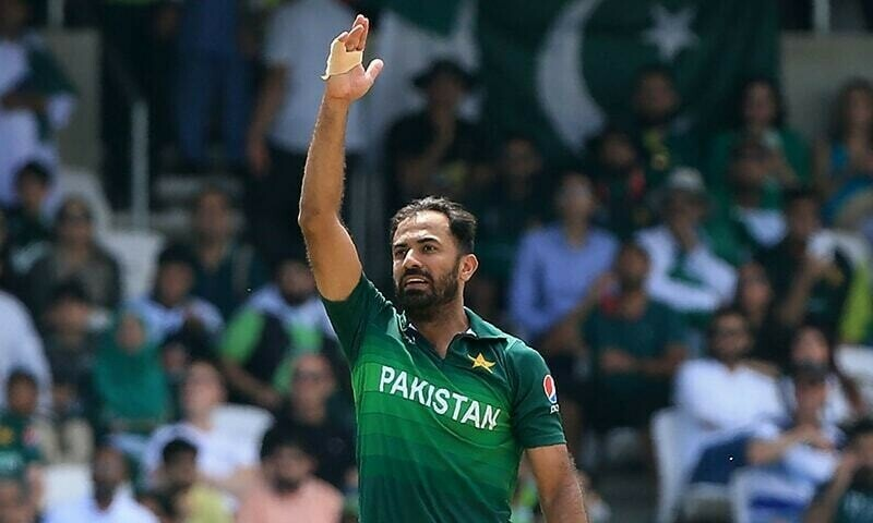Wahab Riaz celebrating during a cricket match in Pakistan team jersey
