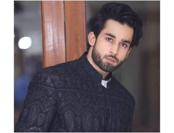 A headshot of Pakistani actor Bilal Abbas Khan, with a beard and styled hair, wearing a black embroidered jacket.
