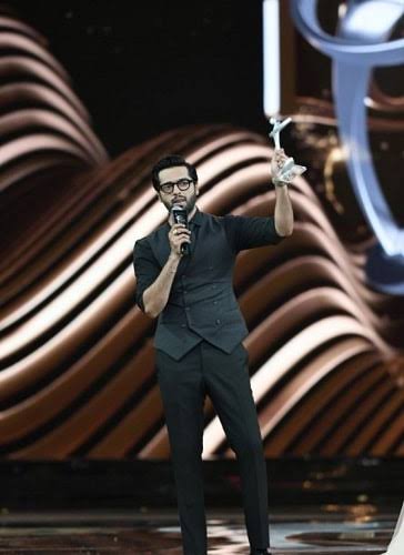 Fahad Mustafa holding an award in an old photo