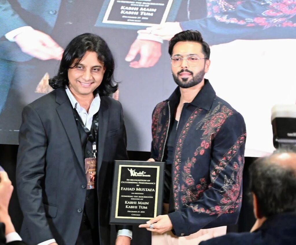 Fahad Mustafa holding two awards