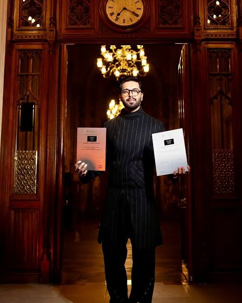 Fahad Mustafa holding an award