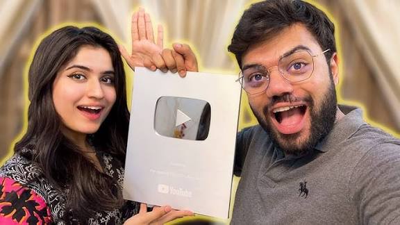 Ducky Bhai holding his Silver Play Button