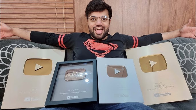 Ducky Bhai holding four YouTube play buttons