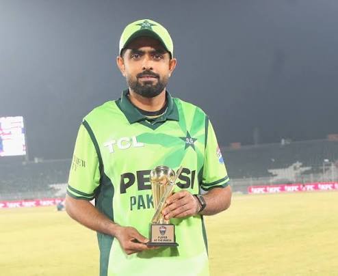 Babar Azam holding a yellow trophy