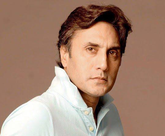 A portrait of Pakistani actor Adnan Siddiqui wearing a light blue polo shirt.
Caption: Pakistani actor Adnan Siddiqui.
