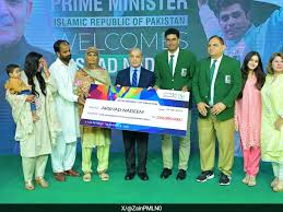 Arshad Nadeem, Pakistani javelin thrower, holding a gold medal on the podium during an international athletics awards ceremony.