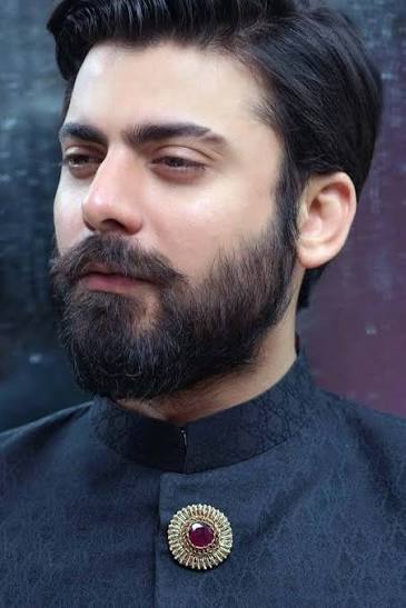 Fawad Khan smiling in a formal portrait
