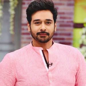  Faysal Qureshi posing for a professional photograph