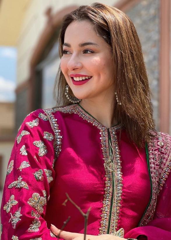 Hania Aamir smiling gracefully in a traditional Pakistani outfit, captured during a 2025 photoshoot 