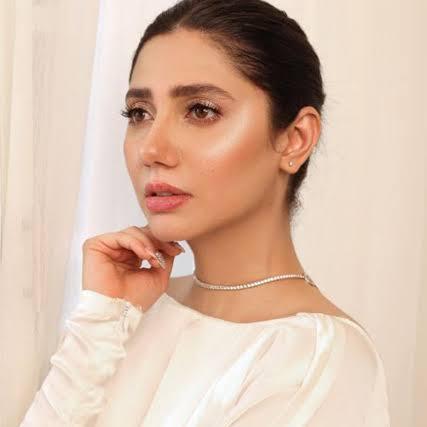 Mahira Khan, Pakistani actress, smiling gracefully while posing for a photoshoot.