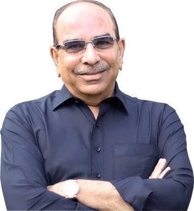 Malik Riaz, Pakistani real estate tycoon and founder of Bahria Town, smiling confidently in a formal setting.