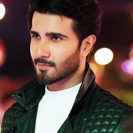 A photograph of Pakistani actor Feroze Khan wearing a black leather jacket and a white t-shirt.