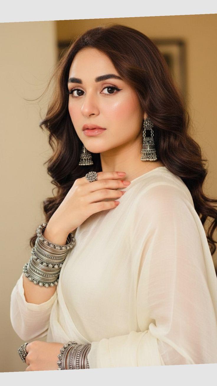 Yumna Zaidi wearing a white suit in a professional profile photo