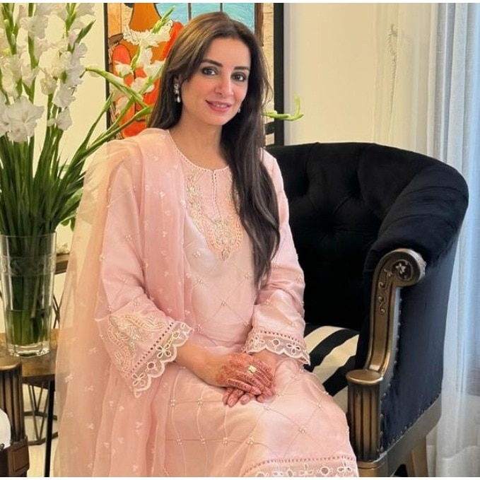  A photograph of Pakistani actor Sarwat Gilani wearing a light pink embroidered outfit.