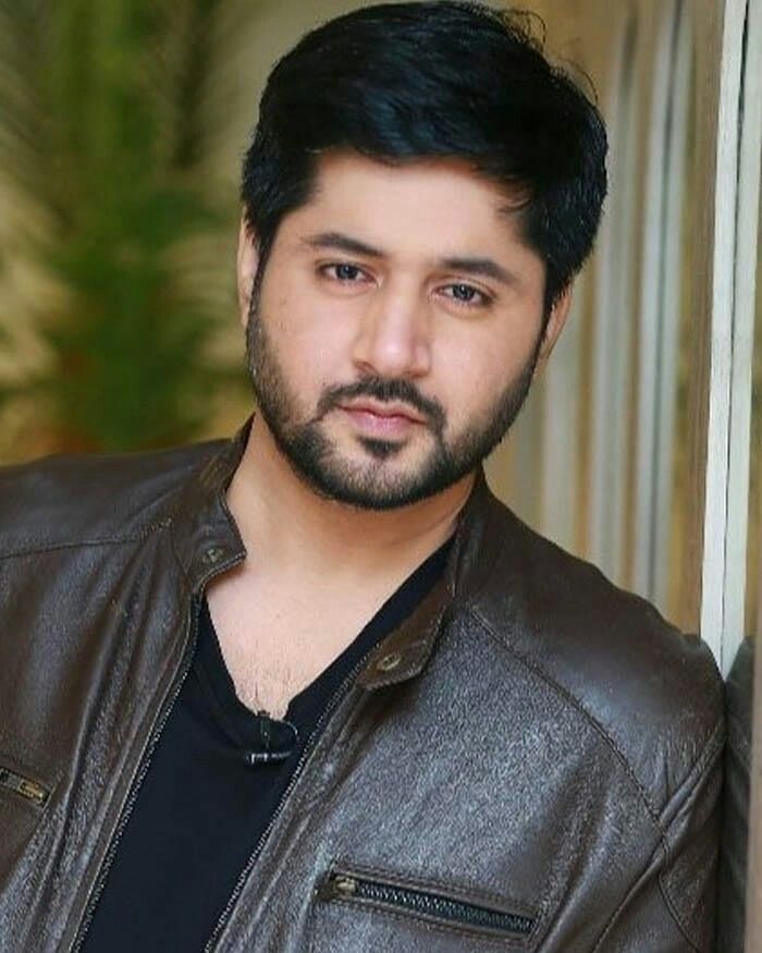 A portrait of Pakistani actor Imran Ashraf wearing a brown leather jacket.
