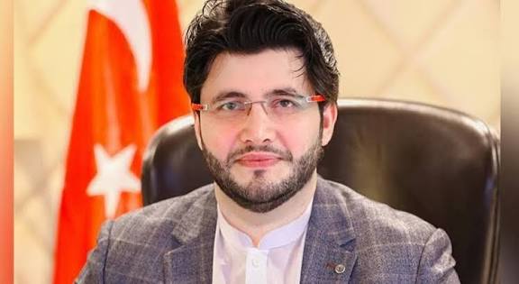 Javed Afridi smiling in a formal portrait