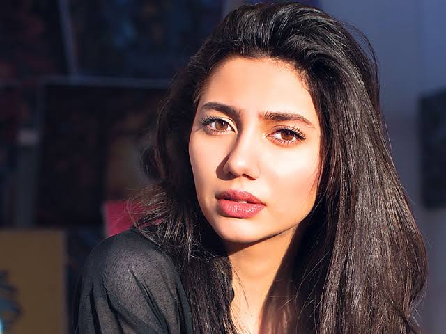 A close-up portrait of Pakistani actress Mahira Khan, with long dark hair and File Name: man_in_denim_jacket_studio.jpg

