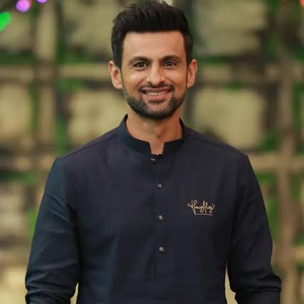 Shoaib Malik smiling in a formal portrait
