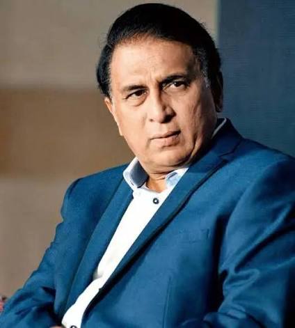 A portrait of former Indian cricketer Sunil Gavaskar wearing a blue suit jacket over a white shirt.
