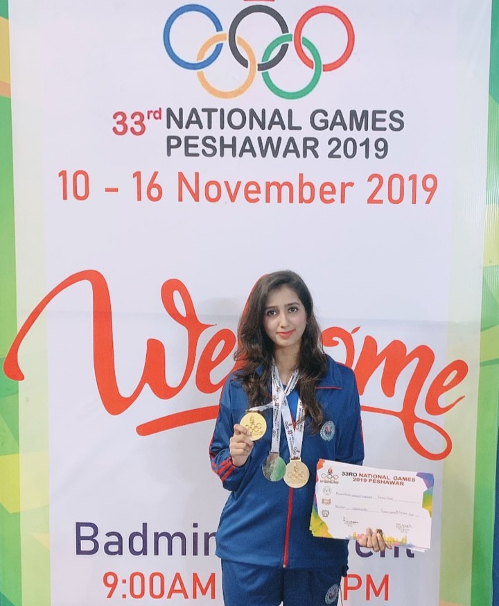 Mahoor Shahzad holding a medal while wearing multiple medals, Pakistani badminton player and national champion