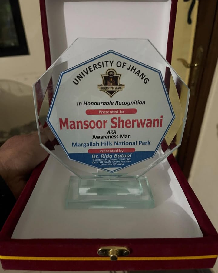 Mansoor Sherwani holding his awareness award, Awareness Man of Pakistan