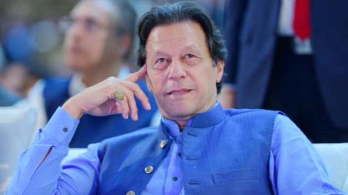Imran Khan in blue traditional waistcoat sitting at formal event

