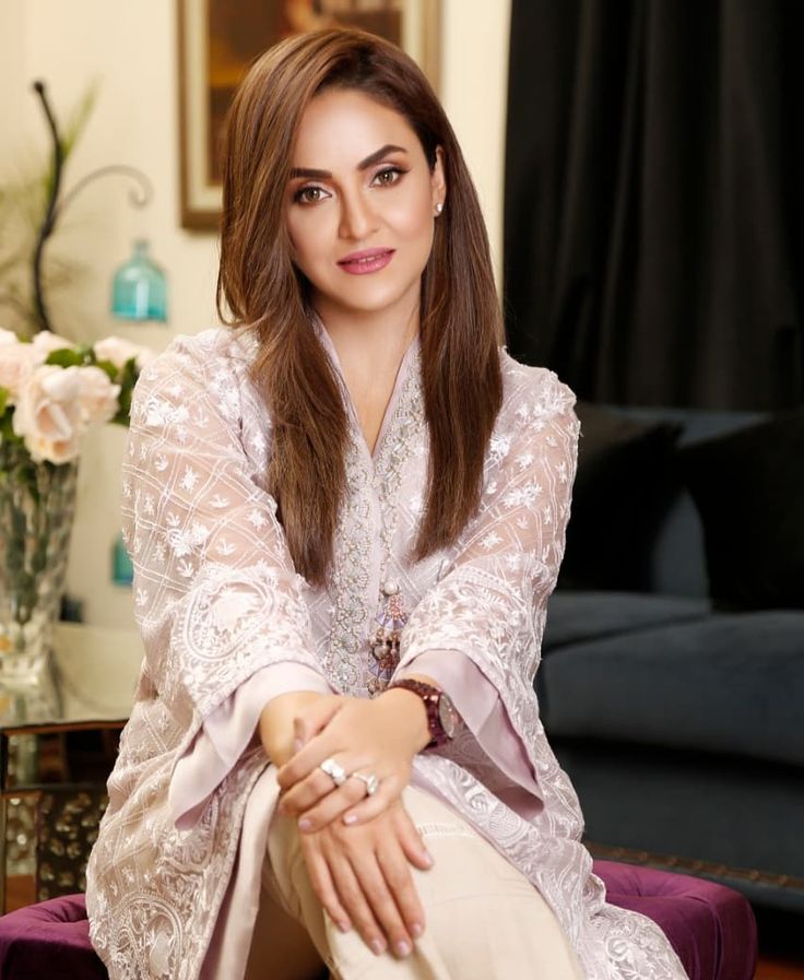 Nadia Khan in elegant embroidered pale pink outfit seated in luxurious interior setting