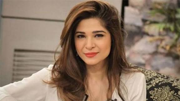 Ayesha Omar smiling elegantly at the camera
