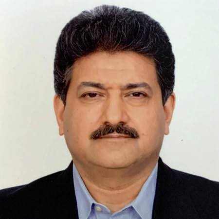 Hamid Mir, Pakistani journalist and TV anchor, smiling at an event
