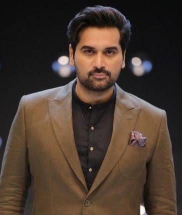 Humayun Saeed smiling while posing for a professional photoshoot