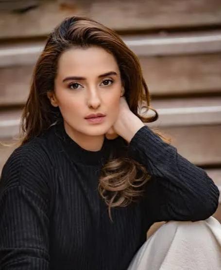 Momal Sheikh smiling in a soft, elegant portrait