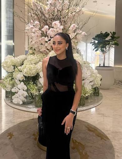 Aleena Nadeem, Pakistani public figure, wearing a black saree in a professional or social setting