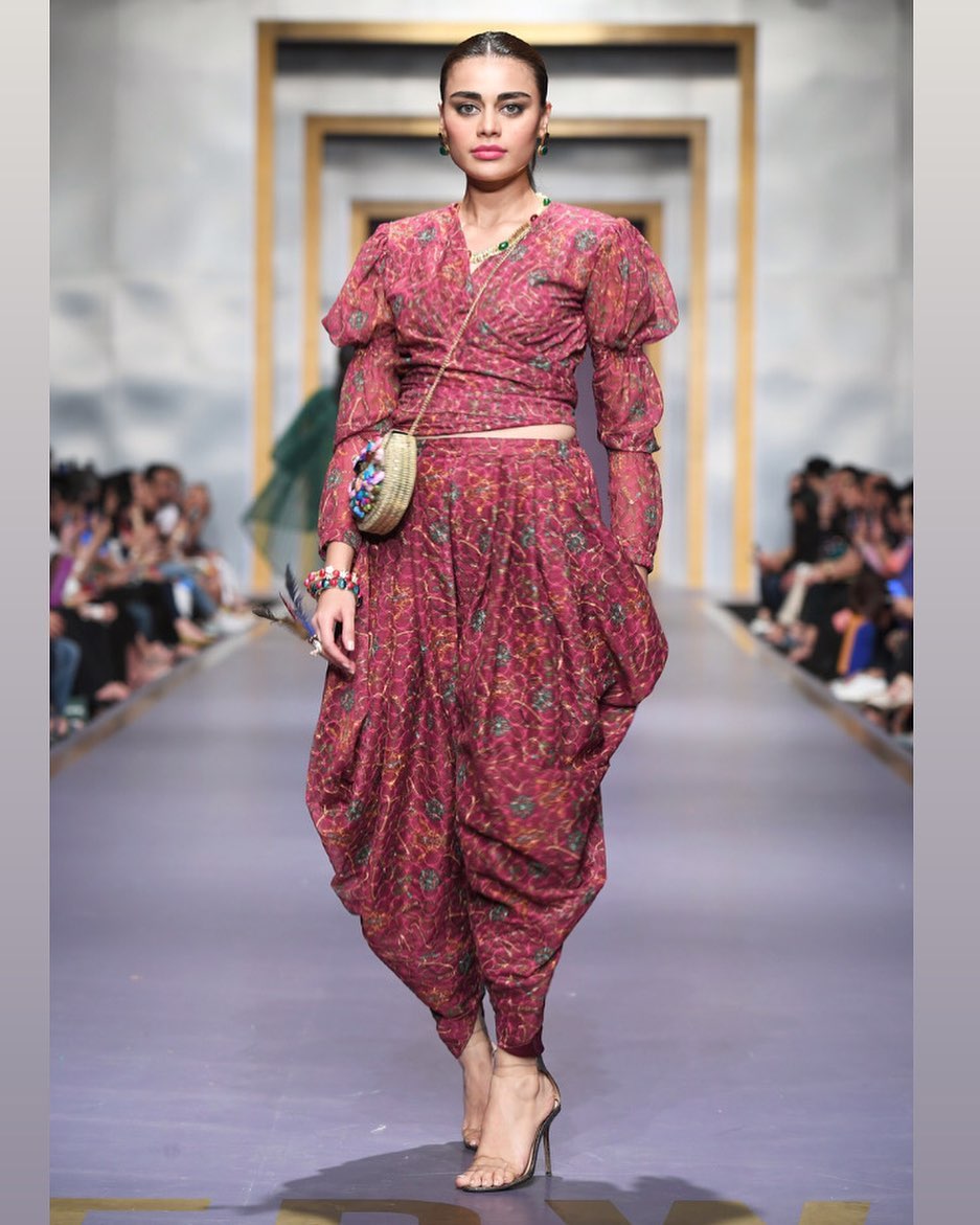Sadaf Kanwal walking on a fashion runway 2025
