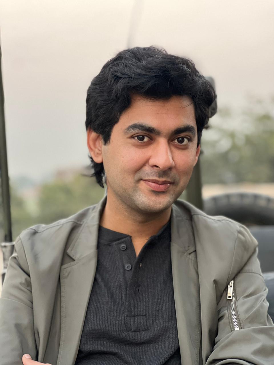 portrait of a young Pakistani visual artist at an exhibition