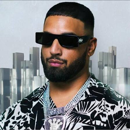 Portrait of Imran Khan, Pakistani singer and songwriter, wearing casual modern attire, posing confidently against a simple studio or urban background.