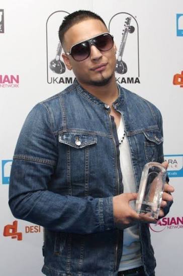 Portrait of Imran Khan, Pakistani singer and songwriter, wearing casual modern attire, posing confidently against a simple studio or urban background