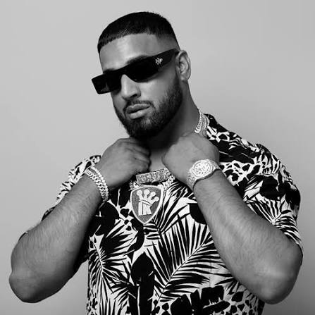 Portrait of Imran Khan, Pakistani singer and songwriter, wearing casual modern attire, posing confidently against a simple studio or urban background